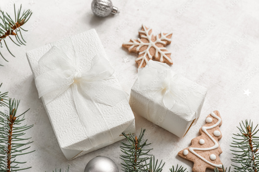 Christmas tree branches with gift boxes and cookies on white background Christmas tree branches with gift boxes and cookies on white background