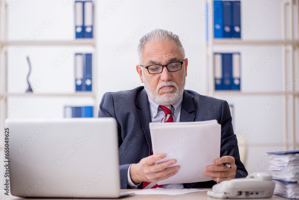 Old male employee and too much work in the office Old male employee and too much work in the office