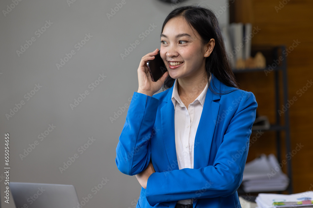 Professional business Asian woman office worker analyst sitting at desk working on laptop thinking on project plan, analyzing marketing or financial data online, calling watching elearning webinar. Professional business Asian woman office worker analyst sitting at desk working on laptop thinking on project plan, analyzing marketing or financial data online, calling watching elearning webinar.