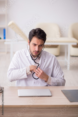 Young male doctor working in the clinic