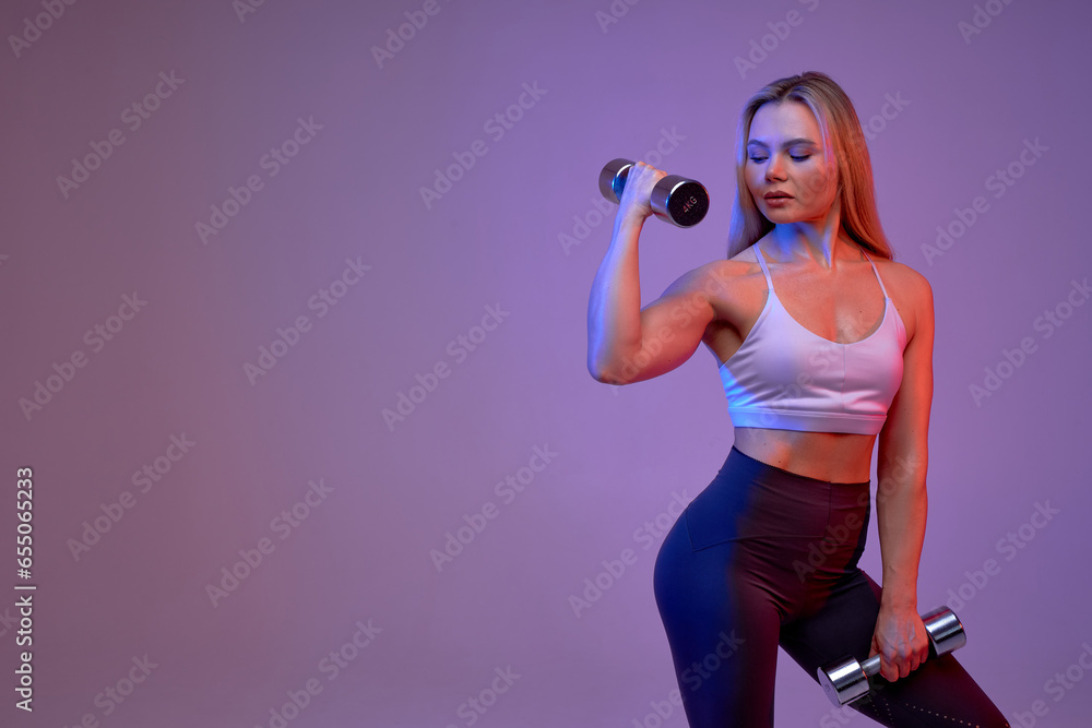 ambitious motivated slim girl doing exercise with dumbbells, free time, wellness. health and body care. woman prepares for competition, weightlifting.challenge ambitious motivated slim girl doing exercise with dumbbells, free time, wellness. health and body care. woman prepares for competition, weightlifting.challenge