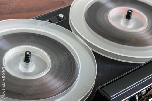 Vintage Magnetic Tape Reel Rewinding on Reel-to-Reel Deck. long exposure