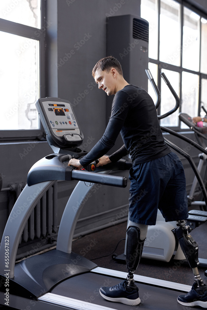 young active man with great willpower working out at sport center, keep fit. never give up. side view full length young active man with great willpower working out at sport center, keep fit. never give up. side view full length