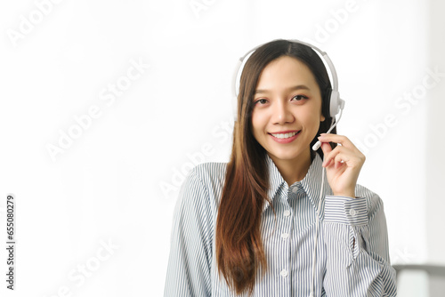 Asian people call center agent in serene work environment, expertly handling client issues via her laptop at organized workspace. representation of modern telecommunication pivotal role in business.