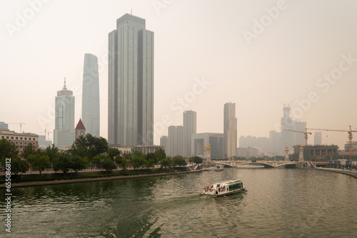 Downtown Tianjin, Tianjin Financial Center and Hai River on a smoggy day photo