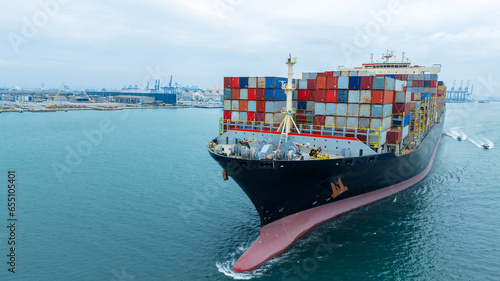 aerial front of cargo ship carrying container and running for export goods from cargo yard port to custom ocean concept freight shipping by ship