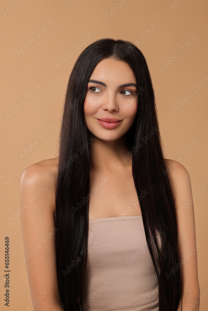 Beautiful woman with long hair on beige background Beautiful woman with long hair on beige background