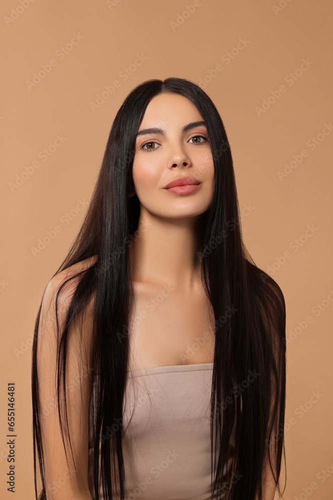 Beautiful woman with long hair on beige background Beautiful woman with long hair on beige background