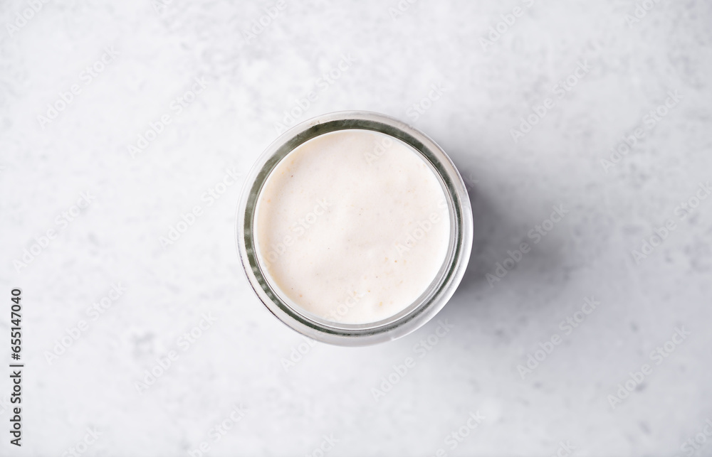 Pumpkin spices coffee creamer in a glass on a white background Pumpkin spices coffee creamer in a glass on a white background