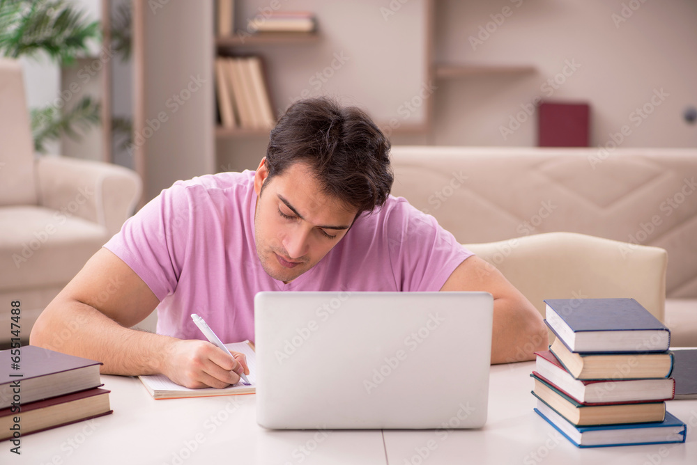 Young male student preparing for exams at home Young male student preparing for exams at home