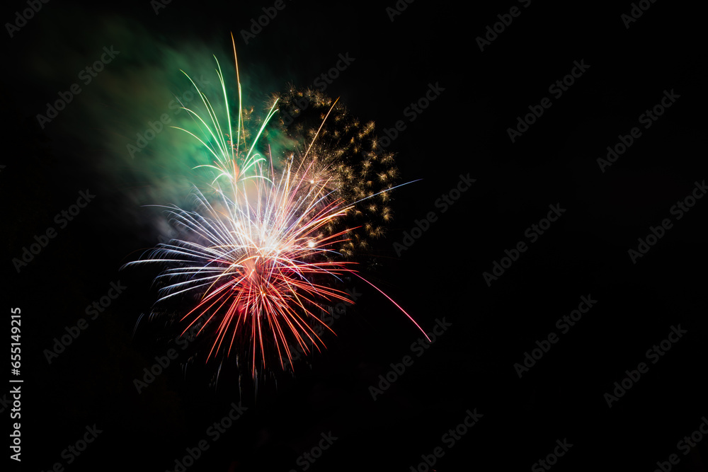 Fototapeta premium Feux d'artifice colorés de différentes couleurs sur le ciel nocturne. Beau fond abstrait