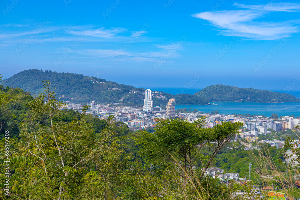 Panorama panoramic Colourful view of Patong Beach Phuket Thailand taken from patong mountains with lush rain forest 