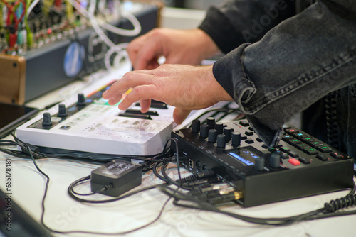 Sound engineer working on a digital sound mixer in a recording studio. © Андрей Журавлев