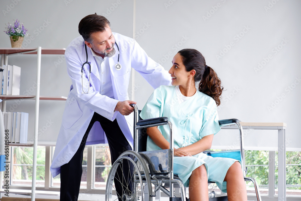 Doctor caring for a female patient sitting in a wheelchair. Doctor caring for a female patient sitting in a wheelchair.