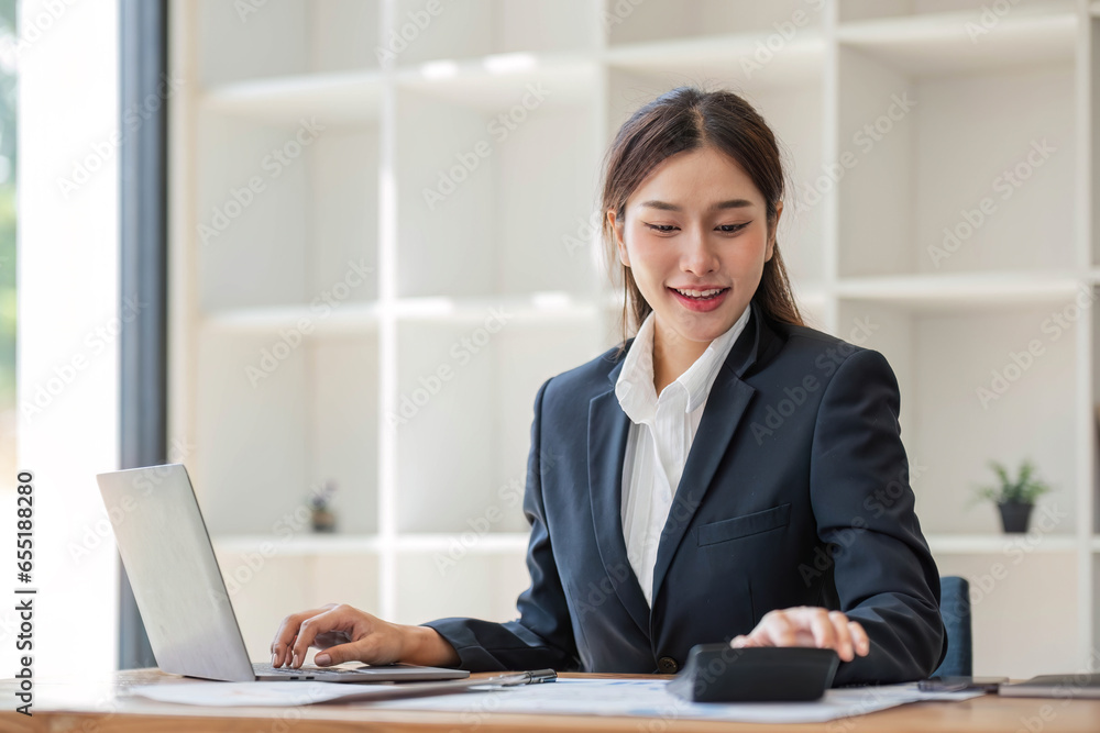 businesswoman using calculator for do math finance on wooden desk in office and business working background, tax, accounting, statistics and analytic research concept businesswoman using calculator for do math finance on wooden desk in office and business working background, tax, accounting, statistics and analytic research concept