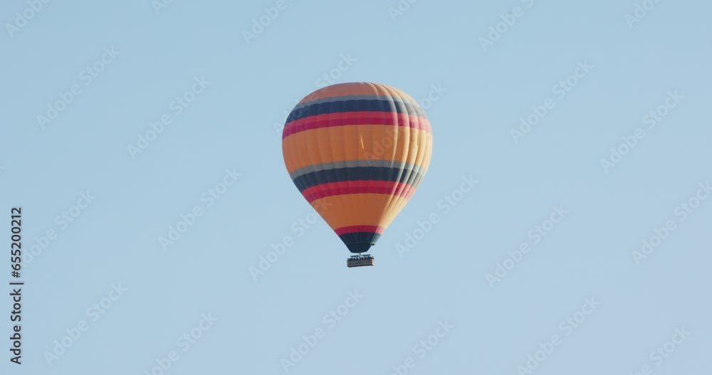 Hot air balloon with tourists, Cappadocia, Turkey Hot air balloon with tourists, Cappadocia, Turkey