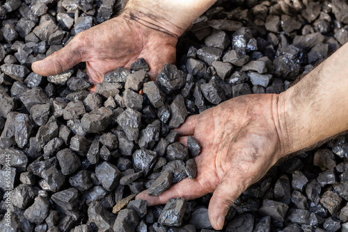 hands digging into coal, industrial mining concept, coal prices, energy cost for households and industry