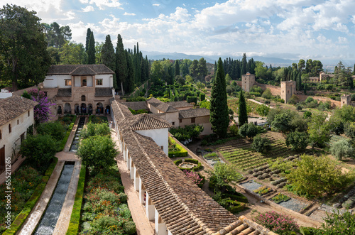 Patio of the Almunia Palace irrigation canal in the Generalife with fountains, fountains and gardens with hedges photo