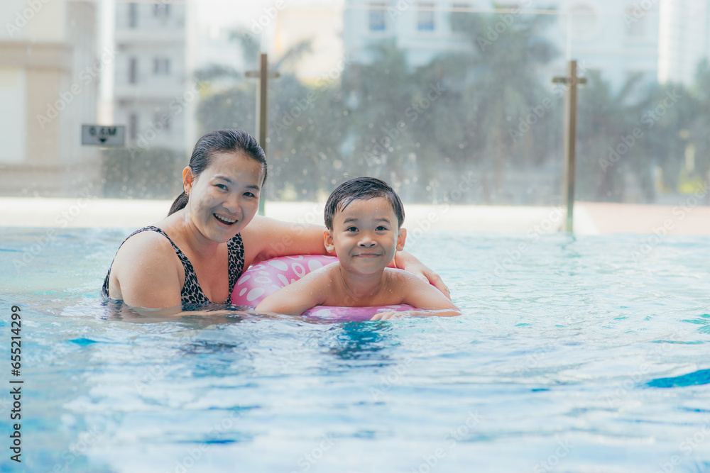 Mother and son having a great time in the pool.