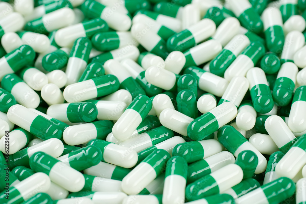 Pharmaceuticals green white capsules. Pills and drugs. Pharmaceutical Industry
