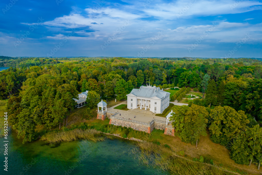 Aerial drone view shot of Uzutrakis Manor in Trakai Galve lake, Lithuania during daylight in autumn