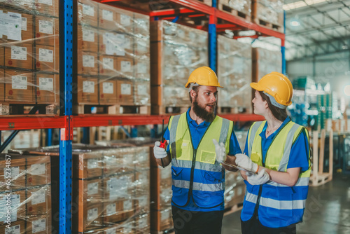 Warehouse staff verify automotive, paper items using handheld device, ensuring precise shipment.