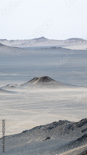 landforms of black mountain peaks which are like moon surfaces.