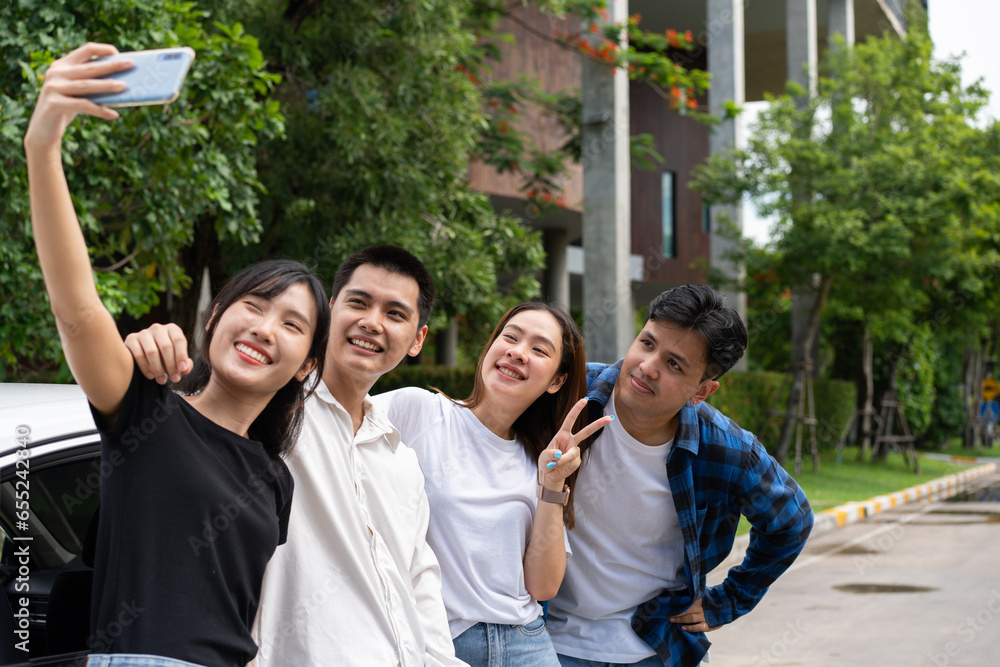 Group of happy young Asian students selfies and videos with smartphones together for vlog and social media on summer vacation. Concept of tourism and travel and road trip, friendship lifestyle. Group of happy young Asian students selfies and videos with smartphones together for vlog and social media on summer vacation. Concept of tourism and travel and road trip, friendship lifestyle.