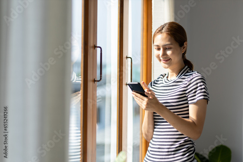 Woman using mobile phone at home.