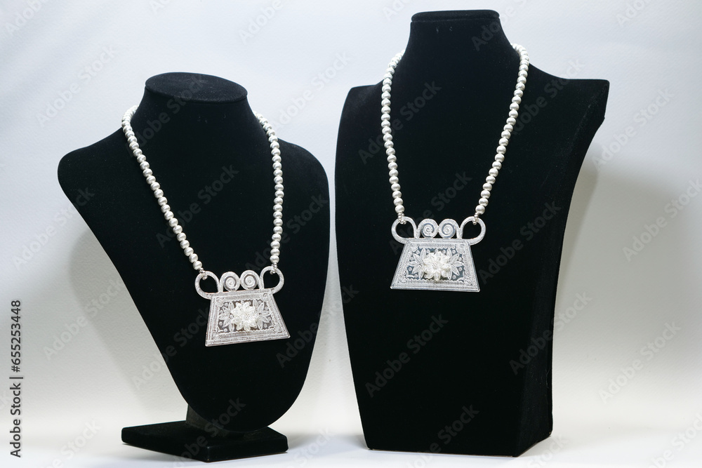 Hmong Phiaj or soul lock pendant made of sterling silver display on black mannequin Hmong Phiaj or soul lock pendant made of sterling silver display on black mannequin