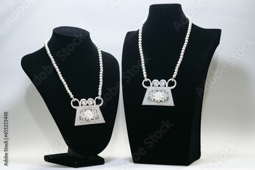Hmong Phiaj or soul lock pendant made of sterling silver display on black mannequin