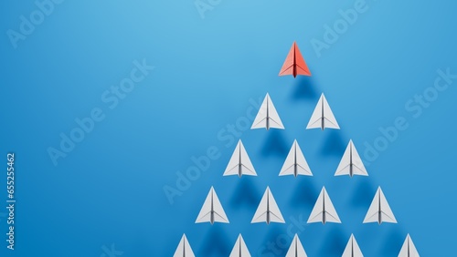 Leaderairplane concept. Red leader paper airplane leading among white on blue background. copy space.3D rendering on blue background.
