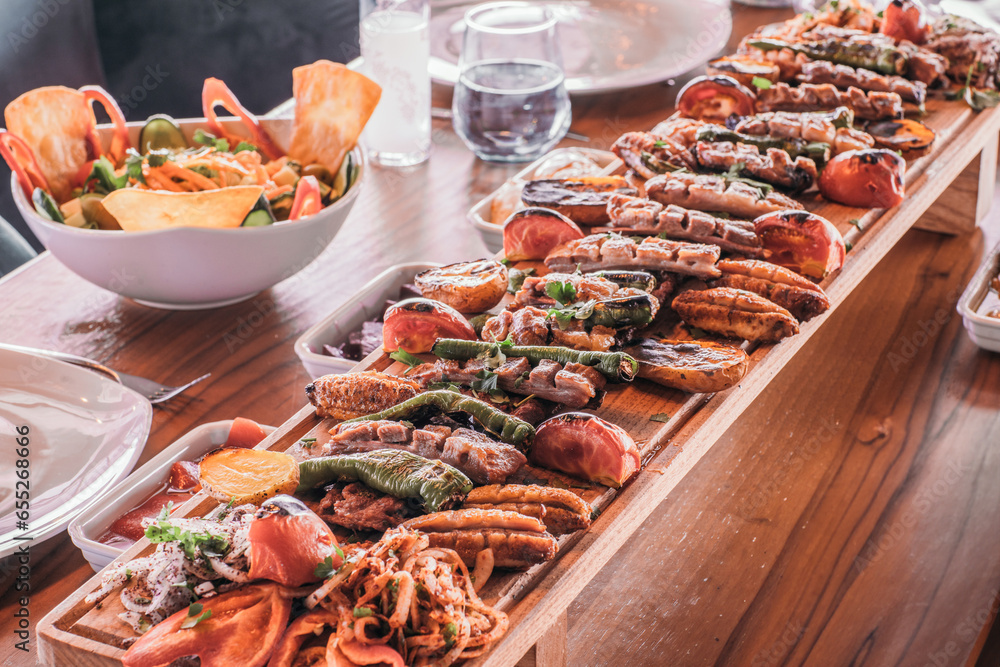 Luxury food in the restaurant. Barbecue,Grilled skewers on the grill. Grilled skewers on fireSalad on the table to serve. Dish on the table. Luxury food in the restaurant,