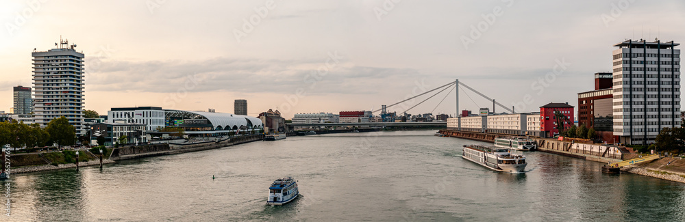 Panorama downstream over the Rhine with ships and view of the shopping center 