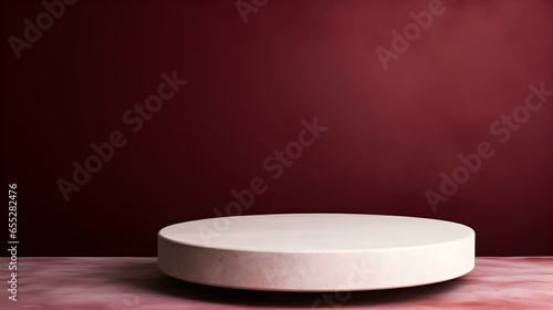 Round Stone Podium in front of a burgundy Studio Background. White Pedestal for Product Presentation