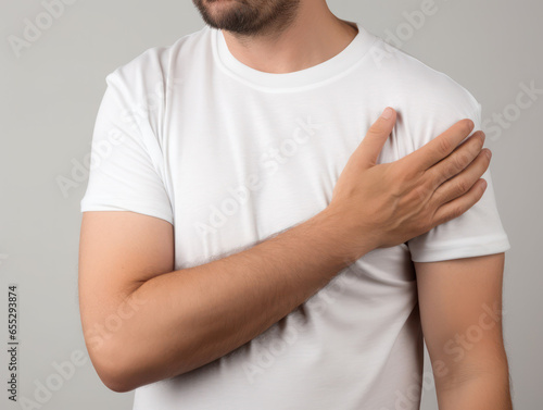 Tender Connection: Hand Touches Heart, Clad in a White T-shirt, a Gesture of Sincerity