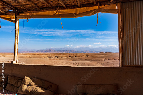 Morocco  desertic landscape in Agafay near Marrakech. View from inside out the Camp. Atlas mountain in the background.