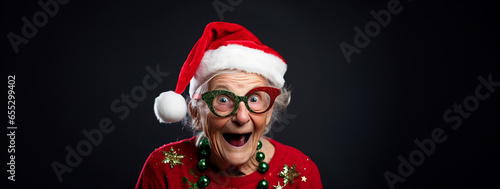 Obraz na plátně Studio portrait of eccentric elderly granny with toothless grin and holiday spir