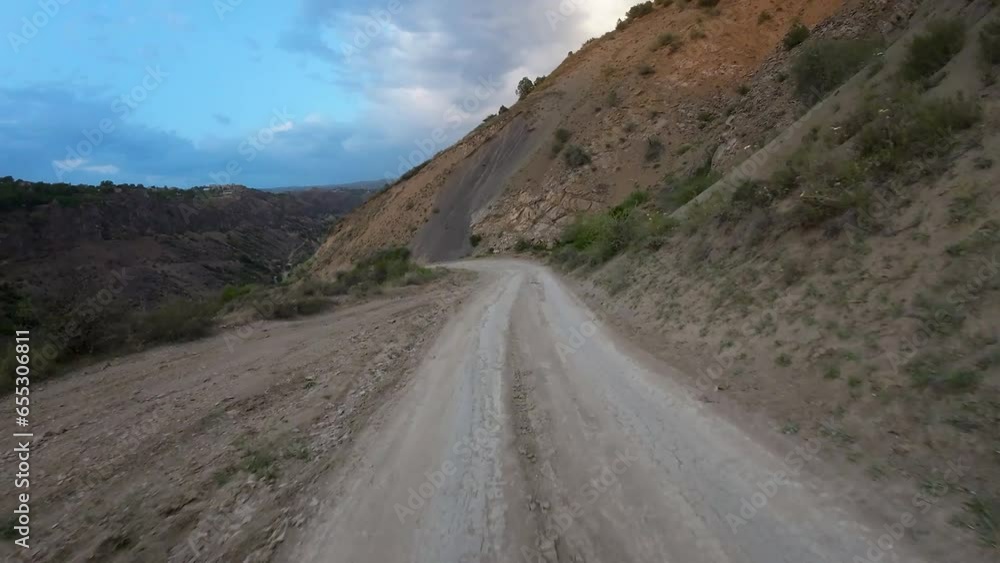 Drone soars above mountainous terrain, capturing winding roads and expansive grasslands, offering a breathtaking aerial view of the majestic landscape Drone soars above mountainous terrain, capturing winding roads and expansive grasslands, offering a breathtaking aerial view of the majestic landscape