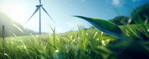 Close-up of a green grass field with a wind turbine on the background representing clean renewable energy, alternative power production and net zero carbon emissions. photo