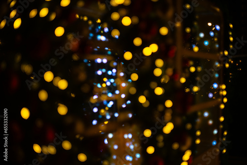 Blurred holiday background with bokeh. Defocused New Year and Christmas illumination