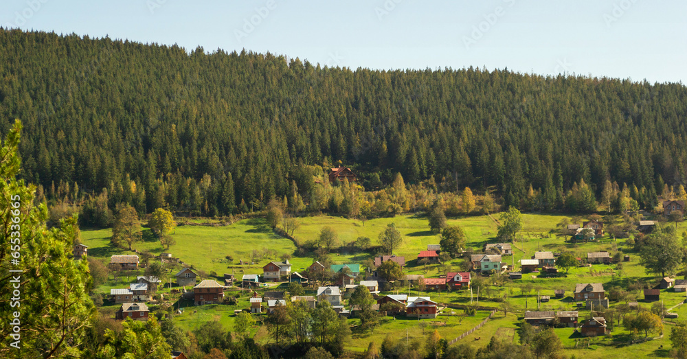 Aerial of a Ukrainian village in the Carpathians during sunny afternoon