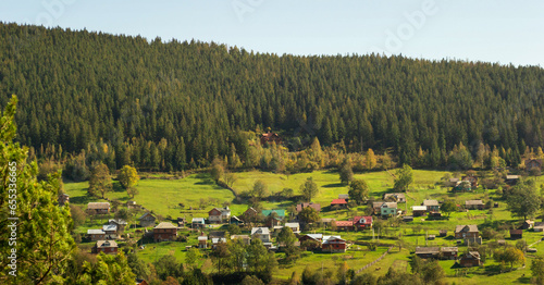 Aerial of a Ukrainian village in the Carpathians during sunny afternoon (ID: 655336665)