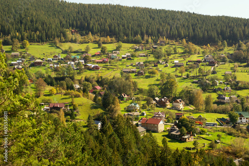 Aerial of a Ukrainian village in the Carpathians during sunny afternoon (ID: 655336811)