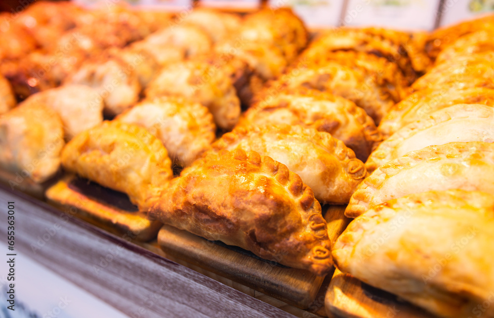 Freshly baked empanadas with different fillings for sale