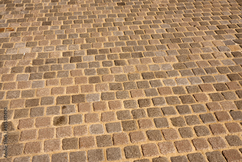 The road is paved with stones as a background.
