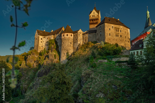 Loket town with castle on hill and river Ohre around in autumn evening