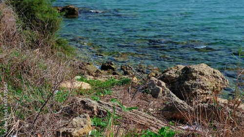 Costa rocciosa e onde del mare in Sicilia photo