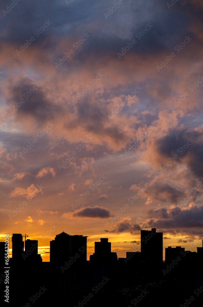 Pink Clouds At Sunset or Sunrise Above an Urban Silhouette.