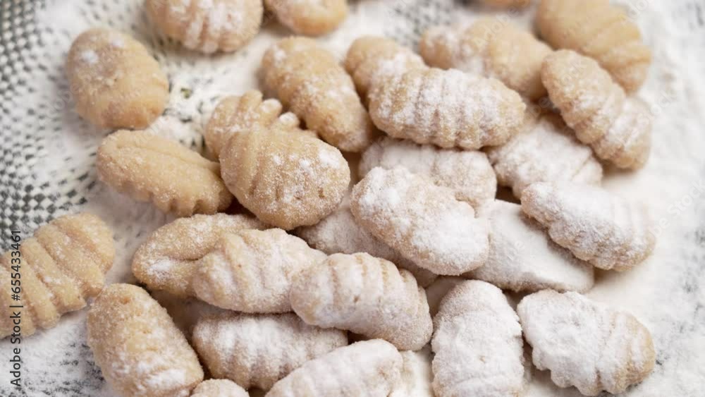 Floured Italian raw gnocchi dumplings. Gluten free product with potatoes and rice flour. Rotation Floured Italian raw gnocchi dumplings. Gluten free product with potatoes and rice flour. Rotation